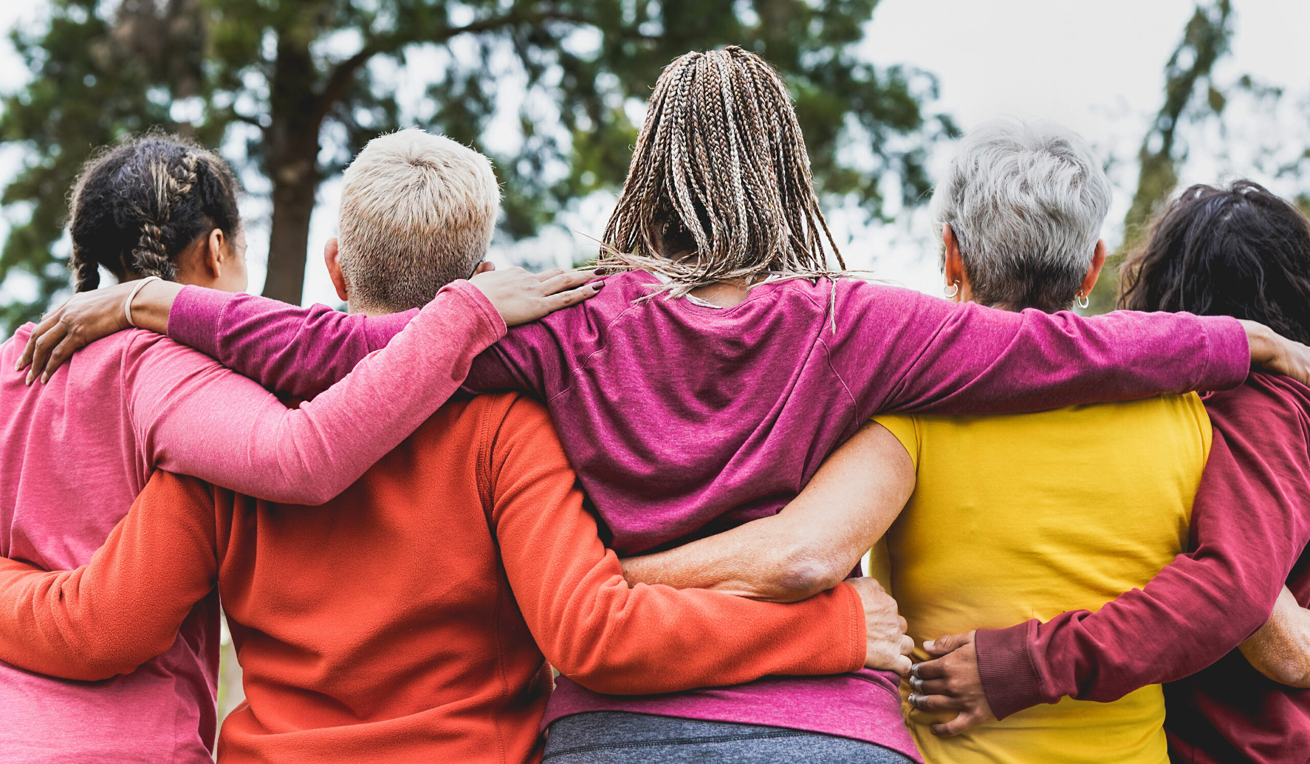 Multi generational women hugging each other outdoor - Multiracial people and teamwork concept